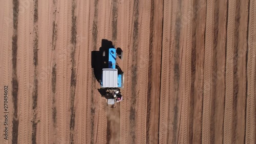 Straight down aerial view of tractor ploughing fields photo