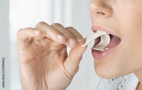 Close up on a beautiful girl while enjoying  gum