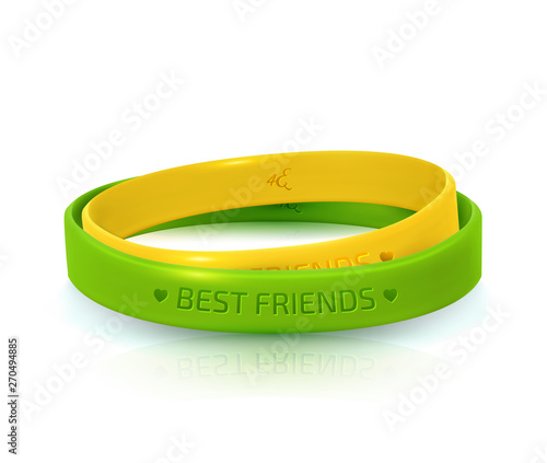 Rubber bracelets for best friends: yellow and green. Friendship Day background, happy holiday of amity. Two silicone wristbands on white background