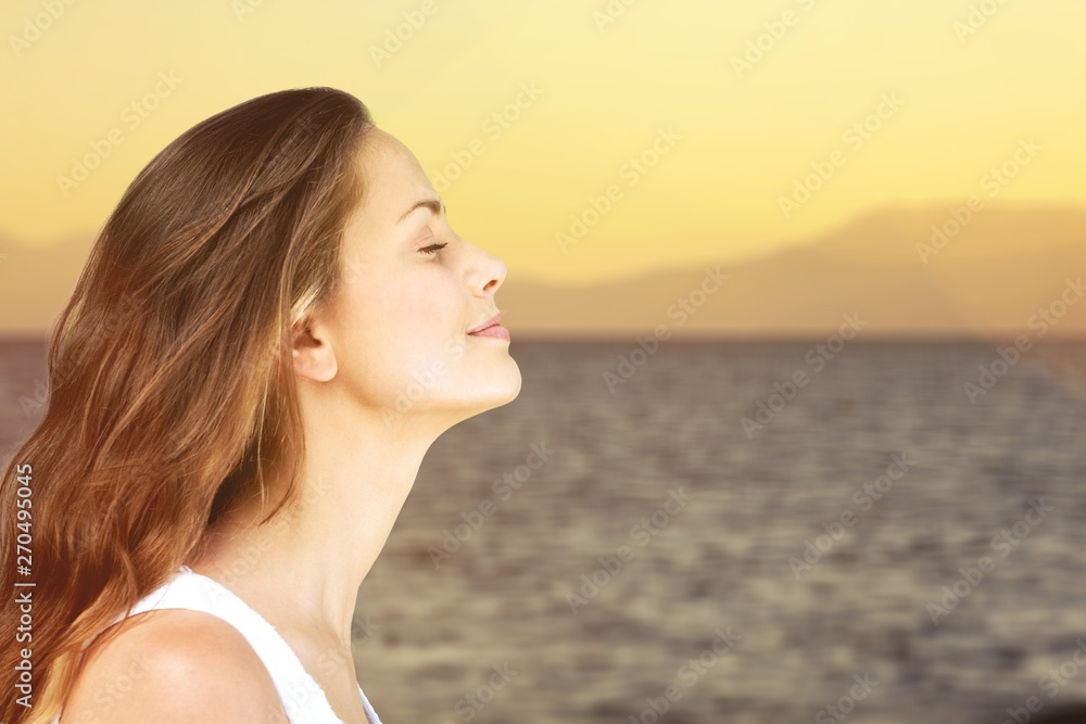 Young woman on field under sunset light Young woman on field under sunset light