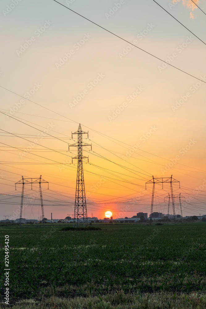 Fototapeta premium Amazing Sunset view over High-voltage power lines in the land around city of Plovdiv, Bulgaria