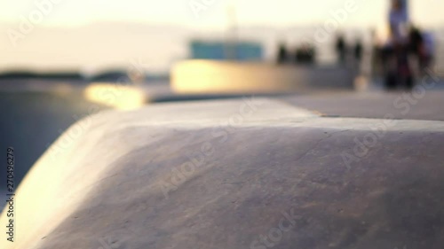 Slow Motion: Skateboarders skateboarding in Venice Beach skate park Los Angeles, California. Concept of modern millennial active lifestyle, friends on summer vacation sport travel.
