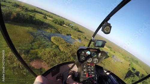 POV from the inside of a helicopter flying over the Okavango Delta