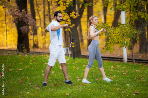 Fitness. Personal Trainer Takes Notes While Woman Exercising Outdoor