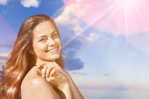 Young beautiful woman on beach at sunny day