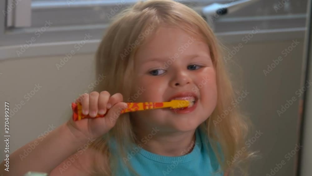 Little girl brushes his teeth in the bathroom Little girl brushes his teeth in the bathroom
