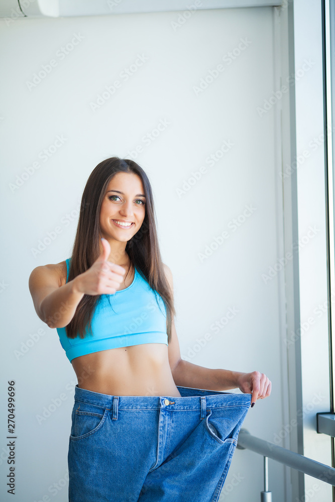 Diet. Dieting concept. Woman in Sportswear Measuring Her Waist