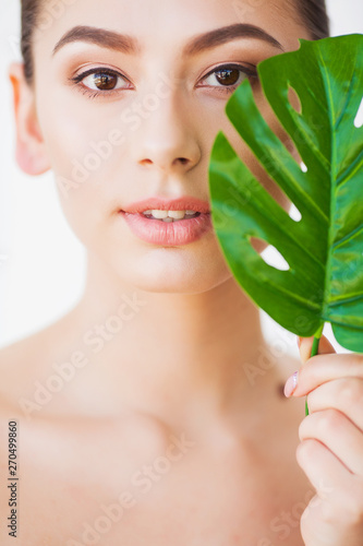 Beauty Woman Face With Healthy Skin And Green Plant