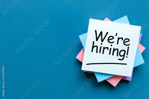 WE ARE HIRING CONCEPT ON bright background at new job place. Empty space for text