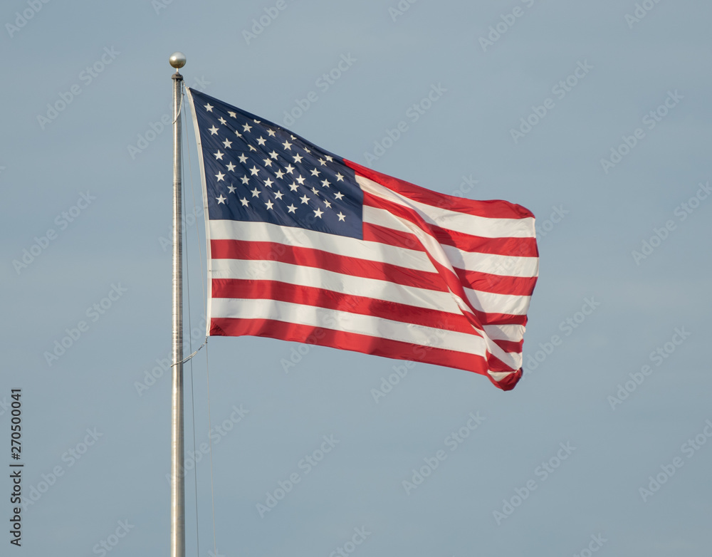 Obraz premium American flag flies on a sunny day