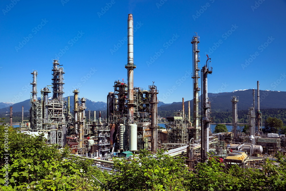 Fototapeta premium Oil refinery on a background of nature, Burrard Inlet and mountain view