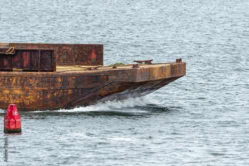 Empty barge heading into port photo