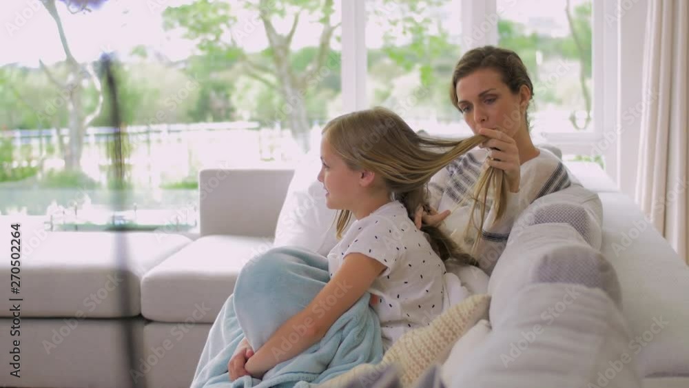 Mom tying daughters hair Mom tying daughters hair
