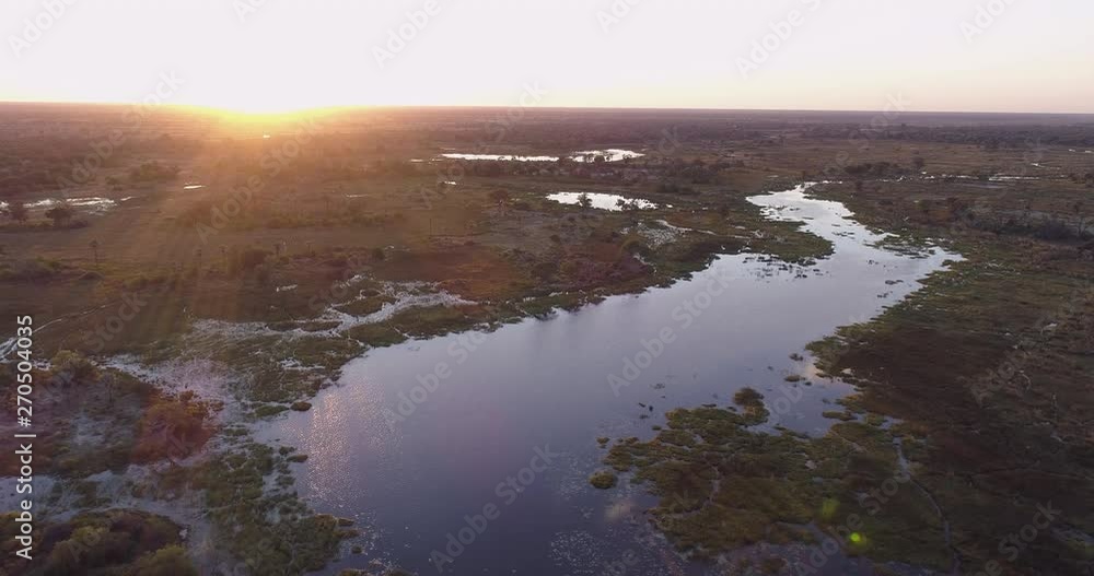 Aerial fly over view of the waterways and lagoons of the Okavango Delta at sunset Aerial fly over view of the waterways and lagoons of the Okavango Delta at sunset