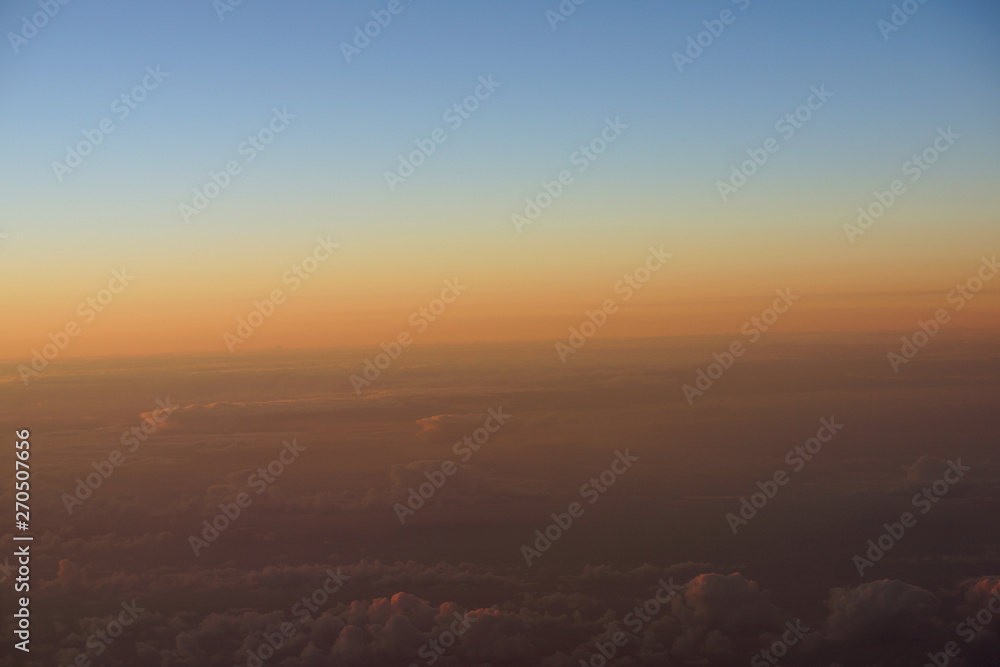 Aerial of Sunrise light over the world full of clouds