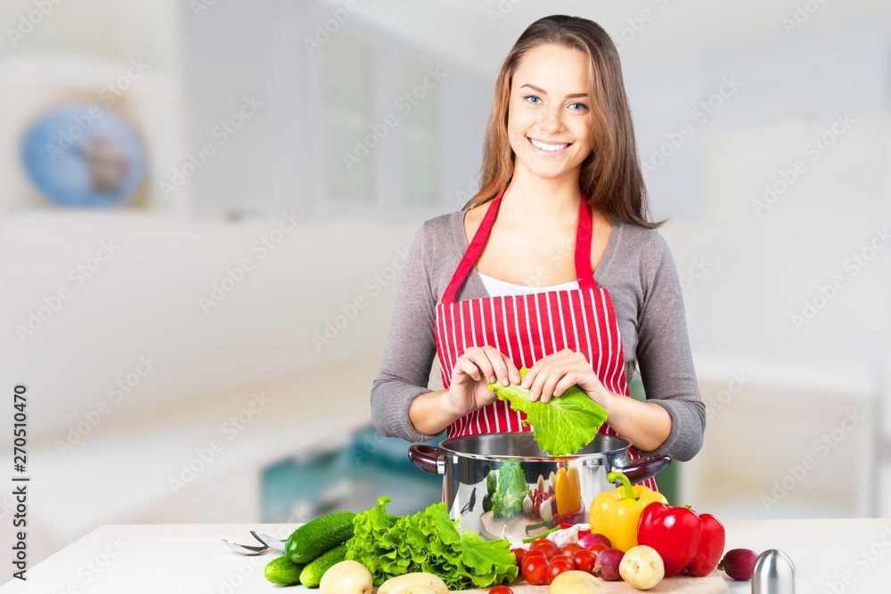 Young beautiful woman with fresh vegetables cooking Young beautiful woman with fresh vegetables cooking