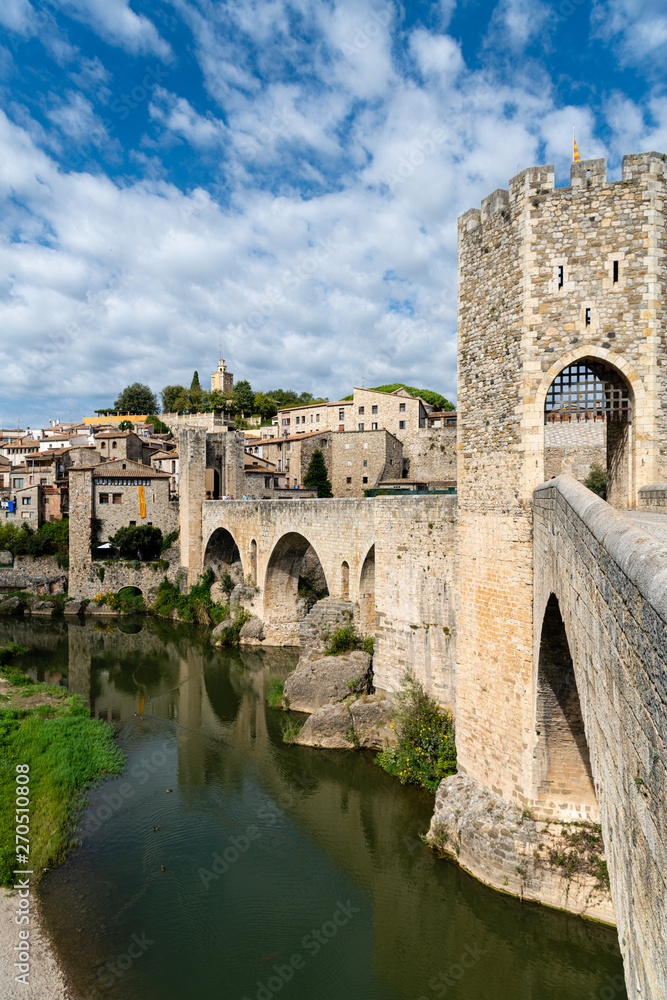 Puente de Besalú - romanesque bridge across the river Fluvia with arches and defence towers in Besalu, Girona, Spain.