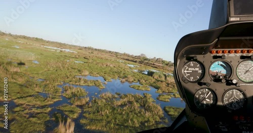 POV from pilot from the inside of a helicopter while flying over the Okavango Delta photo