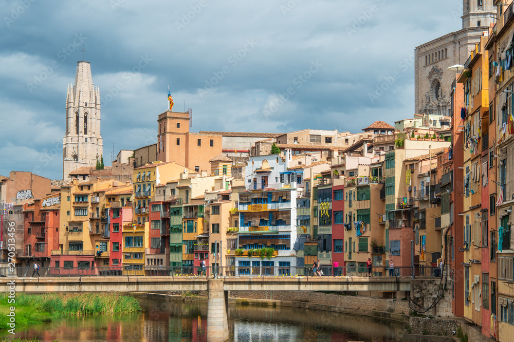 Collegiate Church of Sant Felix and multi colored houses from bridge on the Onyar River, Girona Collegiate Church of Sant Felix and multi colored houses from bridge on the Onyar River, Girona