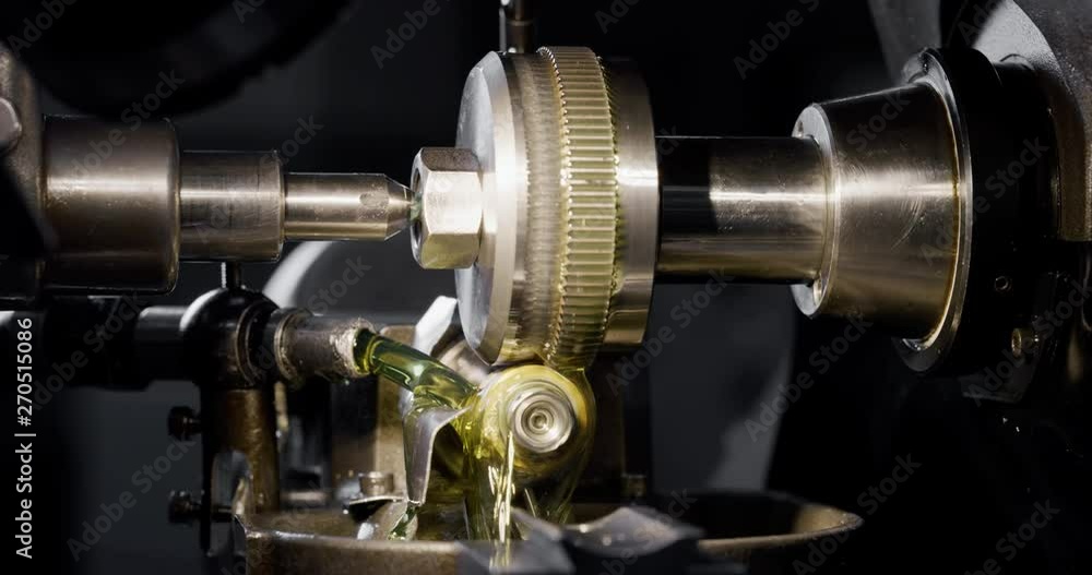 Slow motion macro of specialist is working on production of different gearing details in a workshop in industrial factory. Slow motion macro of specialist is working on production of different gearing details in a workshop in industrial factory.