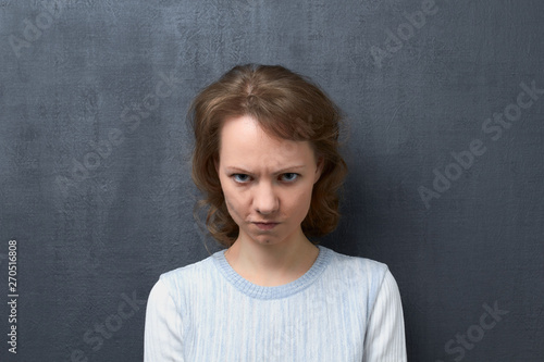 Portrait of angry girl with frowning face © Andrei Korzhyts