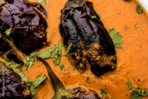 Baingan masala / Eggplant / brinjal curry served in bowl or pan, selective focus photo