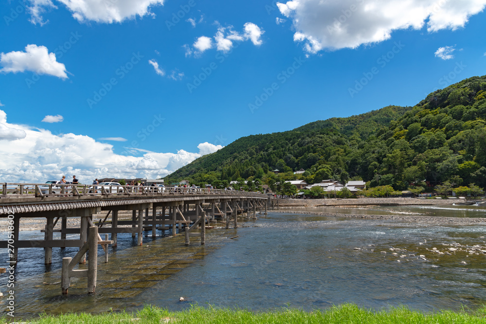 Togetsu-kyo bridge over katsuragawa river with colourful forest mountain background in Arashiyama district. Arashiyama is a nationally designated Historic Site and Place of Scenic Beauty. Kyoto, Japan