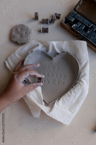 Application of the inscription on a plate of clay before firing