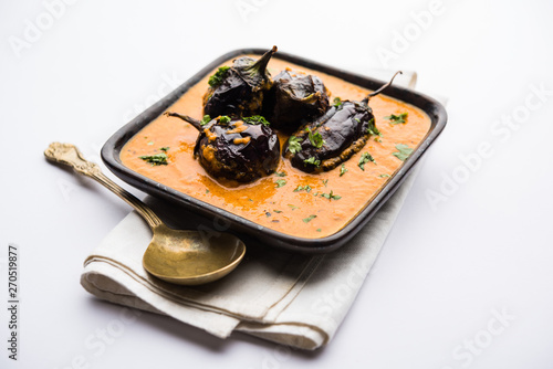 Baingan masala / Eggplant / brinjal curry served in bowl or pan, selective focus photo