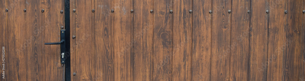 Wood texture background surface with old natural pattern. Wooden brown planks for house gate. Wood texture background surface with old natural pattern. Wooden brown planks for house gate.