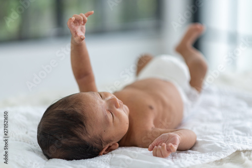 Newborn baby sleeping in bed
