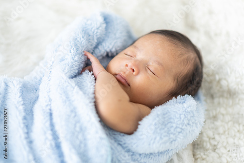Newborn baby sleeping in bed