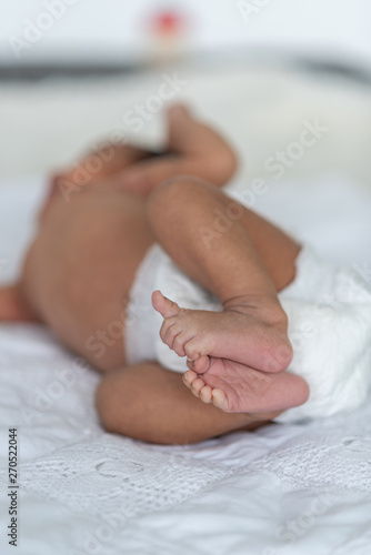 Newborn baby sleeping in bed