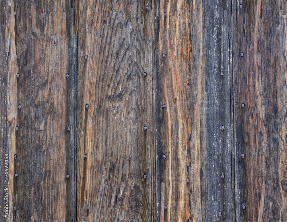 Naklejka premium Weathered, aged boards nailed to a wall.