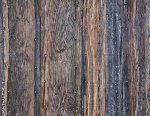 Weathered, aged boards nailed to a wall.