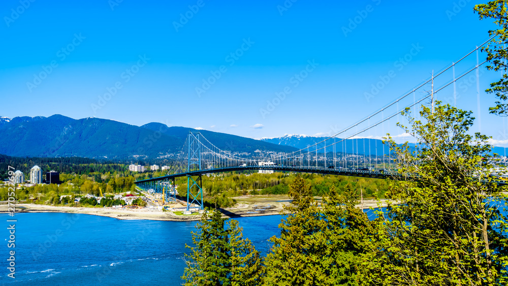View of the Lions Gate Bridge, a suspension bridge that connects Vancouver's Stanley Park and the municipalities of North Vancouver and West Vancouver. Viewed from the Seawall pathway in Stanley Park 