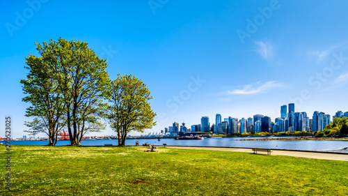 View of the Vancouver Skyline and Harbor. Viewed from the Stanley Park Seawall pathway in beautiful British Columbia, Canada photo