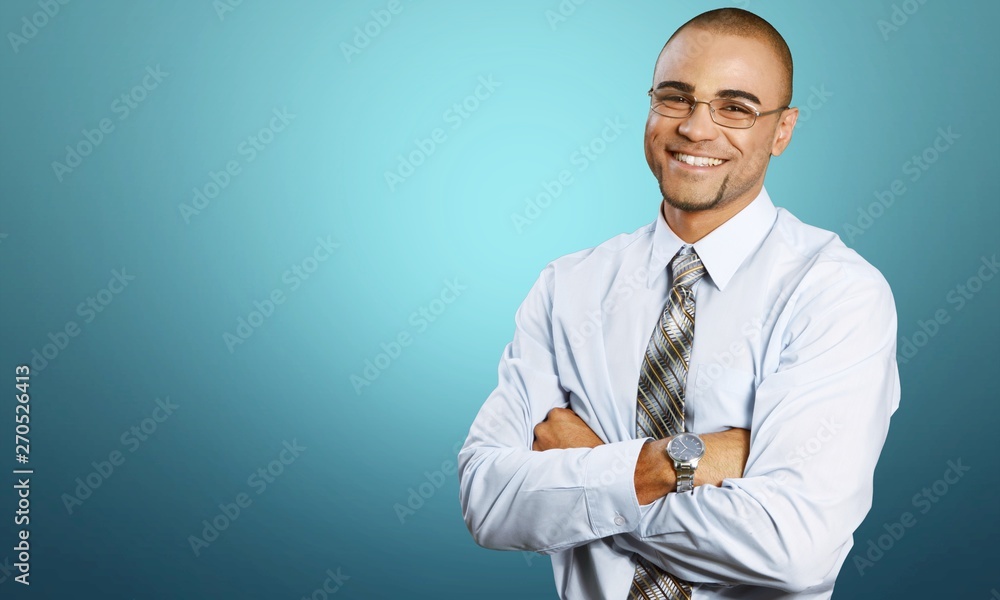 Smiling handsome businessman with crossed hands isolated on white Smiling handsome businessman with crossed hands isolated on white