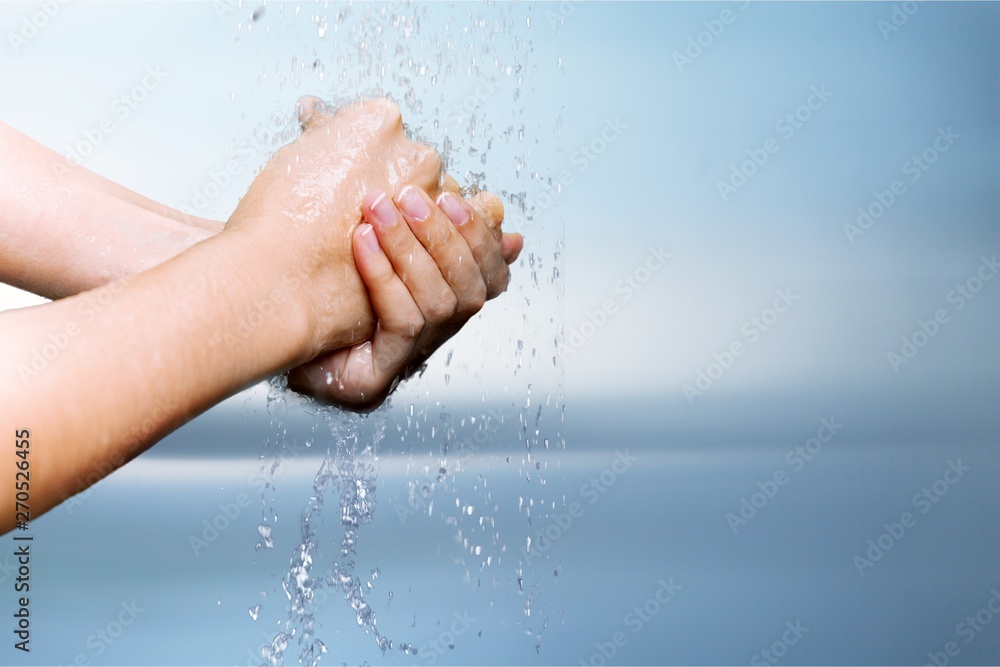 Man washing hands in clean water on blue background