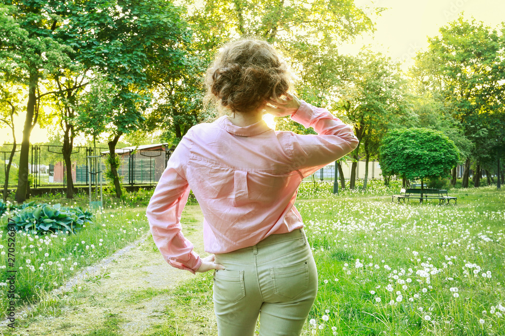 A woman walking in a fabulous garden. A woman walking in a fabulous garden.