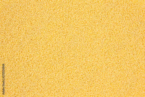 Foto Background texture of couscous grains. Top view.