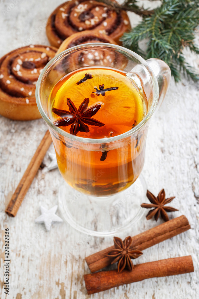 Glass of hot steaming tea among christmas decorations Glass of hot steaming tea among christmas decorations