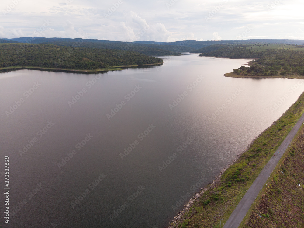 Drone shot Aerial view landscape scenic of big river reservoir dam with nature forest and mountains in tropical land