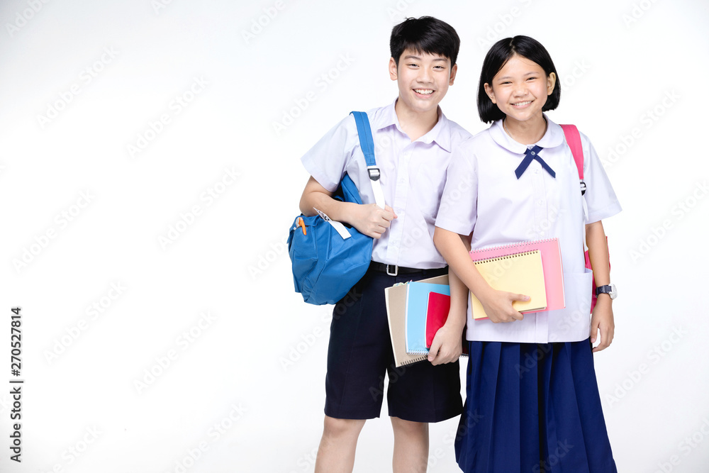 Two asian smiling school kids with colorful stationery,