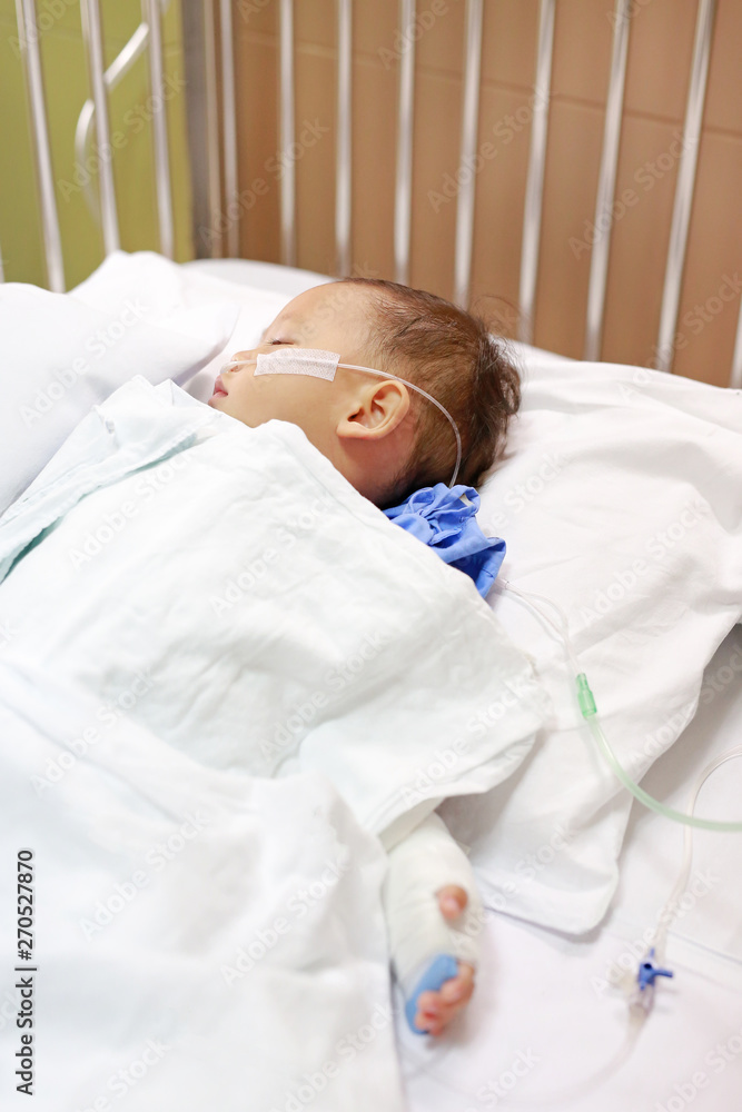 Baby boy with breathing tube in nose receiving medical treatment. Intensive care and attaching