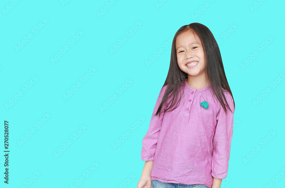 Smiling little Asian child girl isolated on cyan background with copy space. Happy kid. Smiling little Asian child girl isolated on cyan background with copy space. Happy kid.