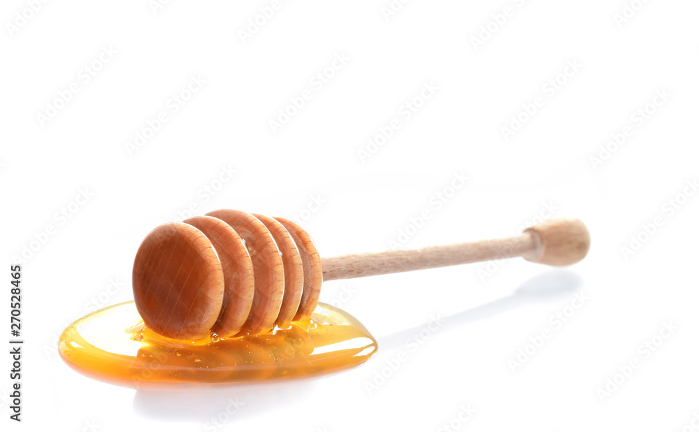 Wooden honey dipper with honey isolated on white Wooden honey dipper with honey isolated on white