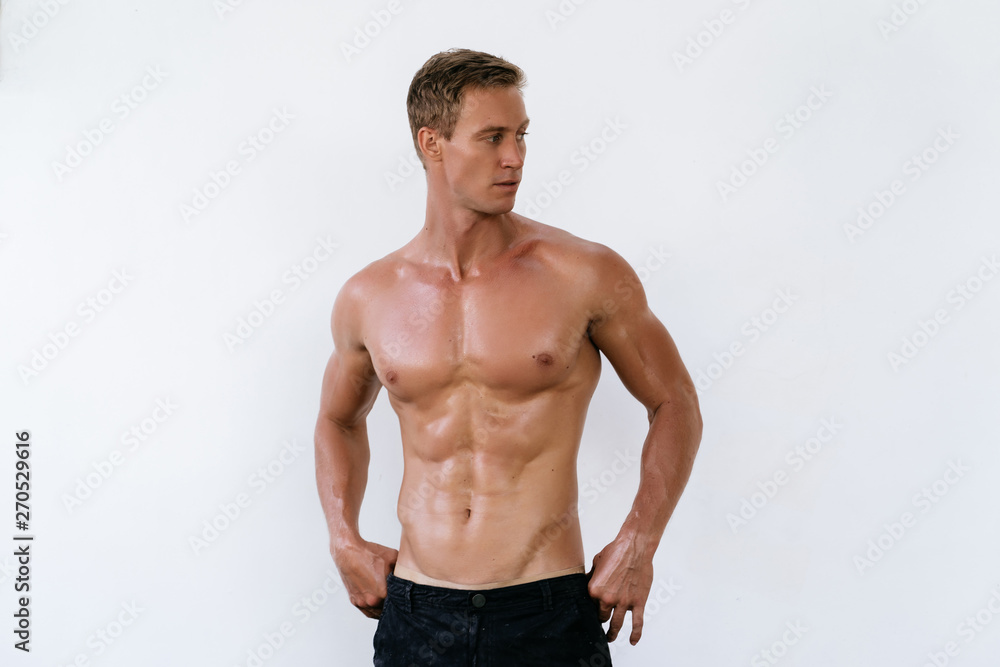 Portrait of sexy athletic man with naked torso poses on white background. Portrait of sexy athletic man with naked torso poses on white background.
