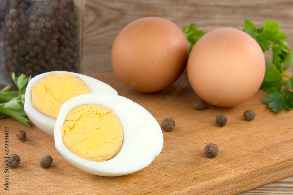Sliced boiled eggs, with parsley leaves. Cooking a salad with boiled eggs. Sliced boiled eggs, with parsley leaves. Cooking a salad with boiled eggs.