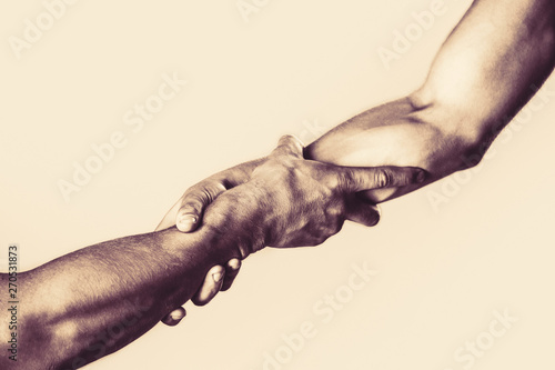 Rescue, helping gesture or hands. Helping hand concept, support. Helping hand outstretched, isolated arm, salvation. Close up help hand. Two hands, helping arm of a friend, teamwork. © Yevhen